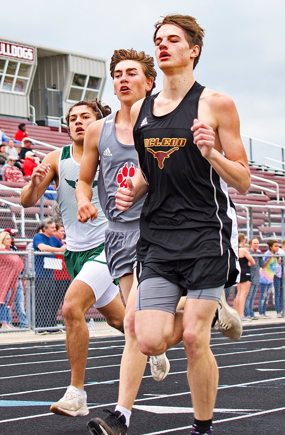 Micah Smith (middle) ran a tough race in the 1600 meters. He came into the final stretch in second place, but three runners eclipsed his kick, just shy of his ticket to the regional meet. [more shutter speed]